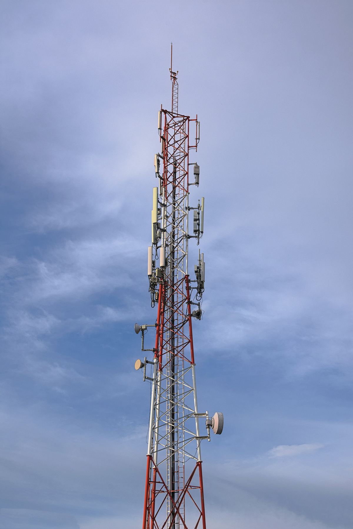 A mobile network antenna tower against the sky.