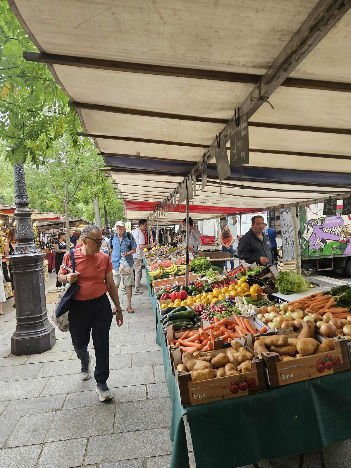 Fresh vegetables and produce laid out at a market stall.